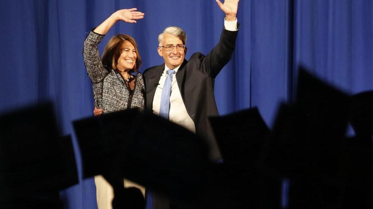 Republican candidate for governor Bill Bryant and his wife, Barbara Feasey, wave to the crowd during a rally at the Greater Tacoma Convention & Trade Center on Saturday.