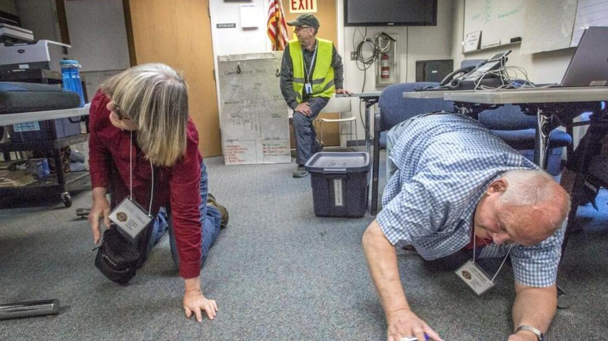 Volunteers of VashonBePrepared, a coalition of Vashon Island disaster preparedness groups, dropped and covered at the group's Emergency Operations Center (EOC) on Vashon Island as the first day of the earthquake drill, Cascadia Rising, began in June 2016.