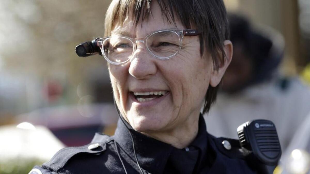 A video camera is visible on the glasses of Seattle Police officer Debra Pelich before a community gathering in Seattle in 2015. Tacoma police will soon try various cameras.