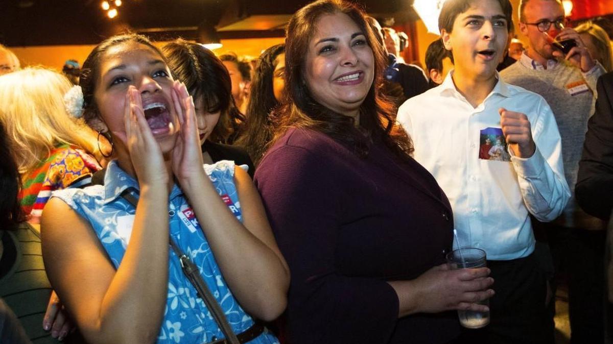 Democrat Manka Dhingra, center, running for State Senator for the 45th district, is congratulated by supporters after she takes the lead after early returns on election night, Nov. 7, 2017, in Woodinville, Wash. (Mike Siegel/The Seattle Times via AP)
