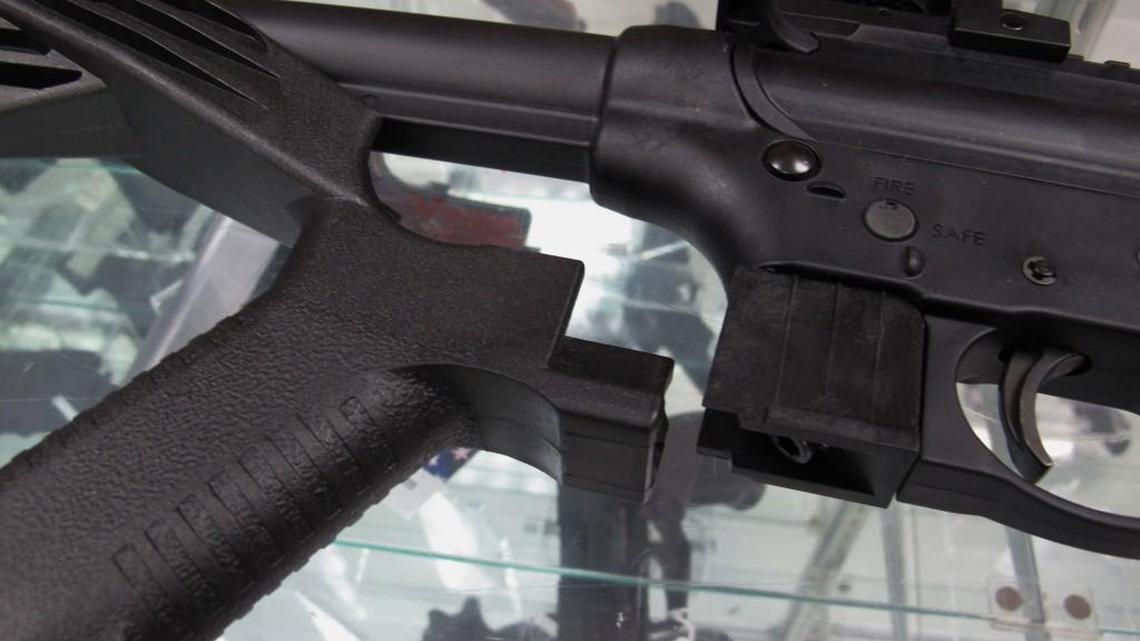FILE - This Feb. 1, 2013, file photo shows a "bump" stock next to a disassembled .22-caliber rifle at North Raleigh Guns in Raleigh, N.C. The gunman who unleashed hundreds of rounds of gunfire on a crowd of concertgoers in Las Vegas on Monday, Oct. 2, 2017, attached what is called a "bump-stock" to two of his weapons, in effect converting semiautomatic firearms into fully automatic ones. (AP Photo/Allen Breed, File)