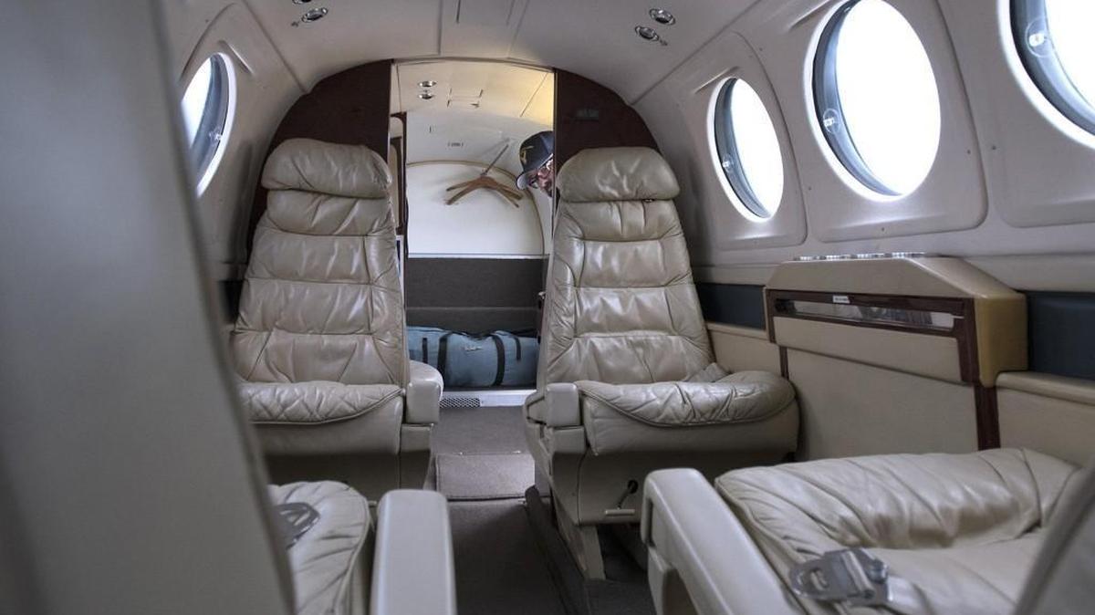 Maintenance supervisor Sam Loska peeks inside the Beechcraft King Air B200 turboprop aircraft at the Washington State Patrol aviation facility at the Olympia Airport on Feb. 15. If a prisoner is deemed too dangerous for a commercial flight, he or she might be transported on the Beechcraft.