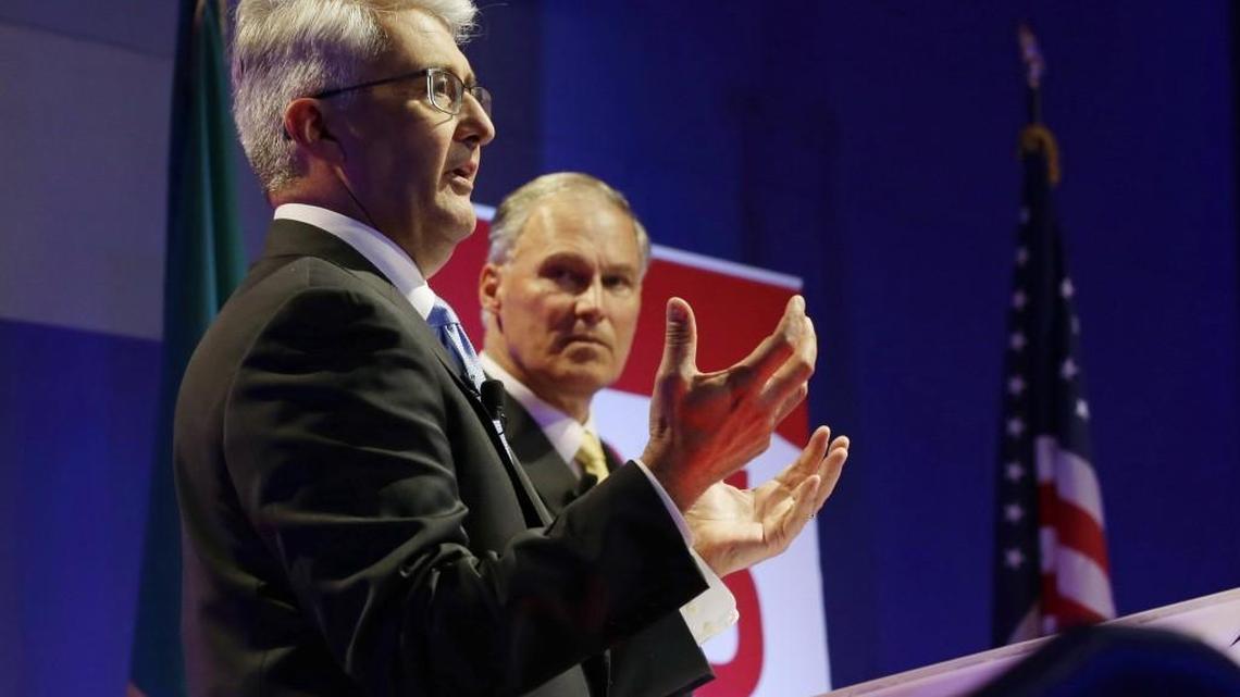Washington Gov. Jay Inslee, right, a Democrat, and Republican challenger Bill Bryant, left, take part in a debate Monday in Seattle.