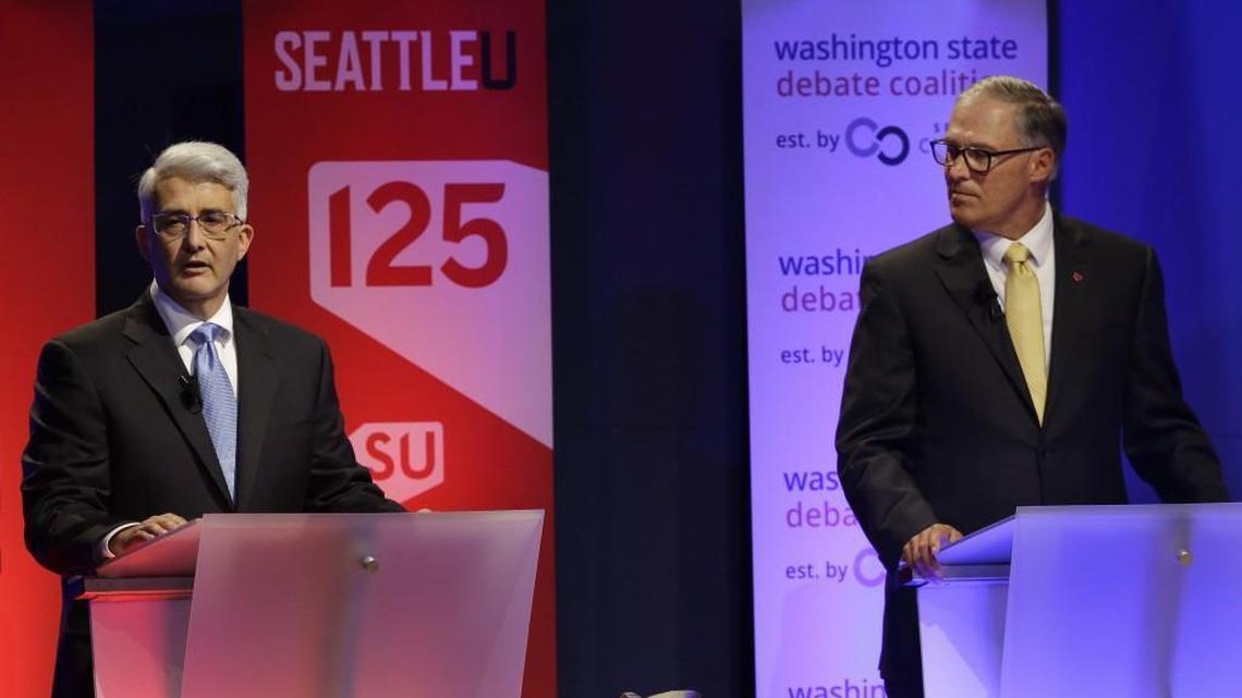 Washington Gov. Jay Inslee, right, a Democrat, and his Republican challenger, Bill Bryant, left, take part in a debate, Monday, Sept. 26, 2016, in Seattle. (AP Photo/Ted S. Warren)