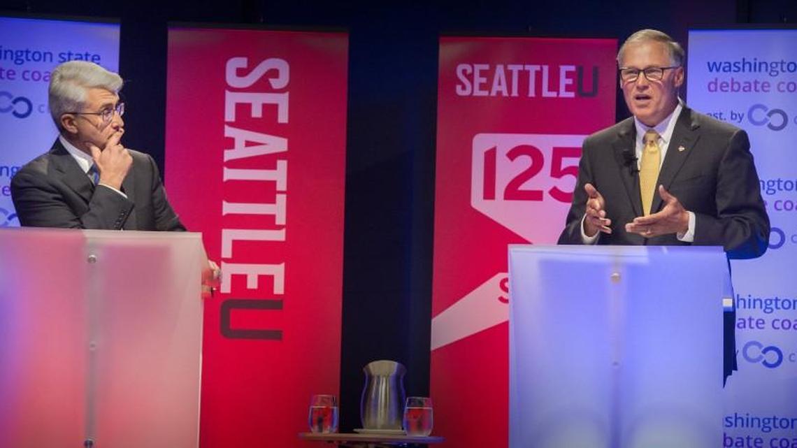 Republican Bill Bryant, left, listens intently to Washington Governor Jay Inslee making a point during the gubernatorial debate at Seattle University on Sept. 26. The two have held three debates.