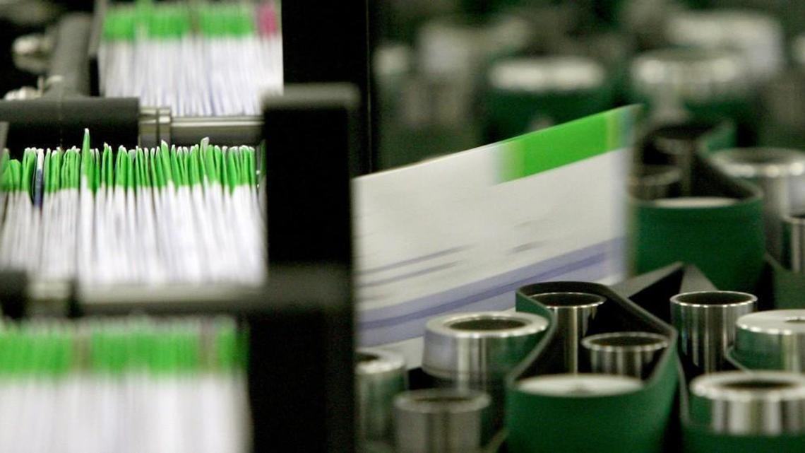 In this file photo from 2012, ballots are counted in Thurston County. Recent changes in the standard mailing times for First Class Mail, combined with rare problems with postmarks, have elections officials telling voters to mail their ballots early.