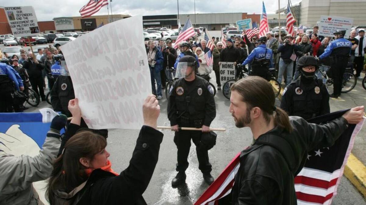 
Tom McCarthy, right, talks with anti-war protesters who gathered in March 2008 near the Tacoma Mall to bring attention to the fifth anniversary of the Iraq War. McCarthy is now running for Tacoma City Council.
