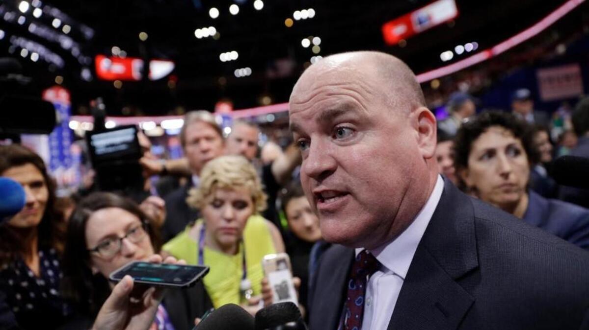 Washington state delegate Eric Minor talks to reporters as he reacts to a roll call vote on the adoption of the rules during first day of the Republican National Convention in Cleveland on Monday.