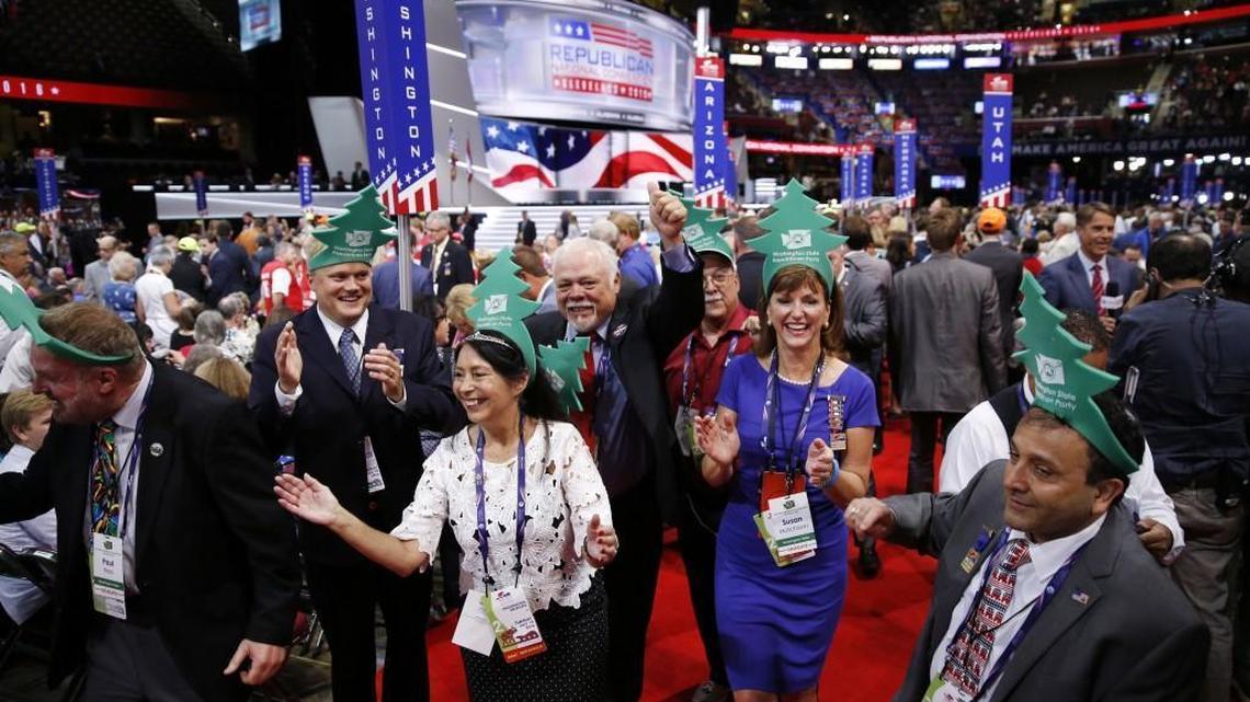Washington delegates cheer during the second day session of the Republican National Convention on Tuesday in Cleveland. They celebrated in green tree hats