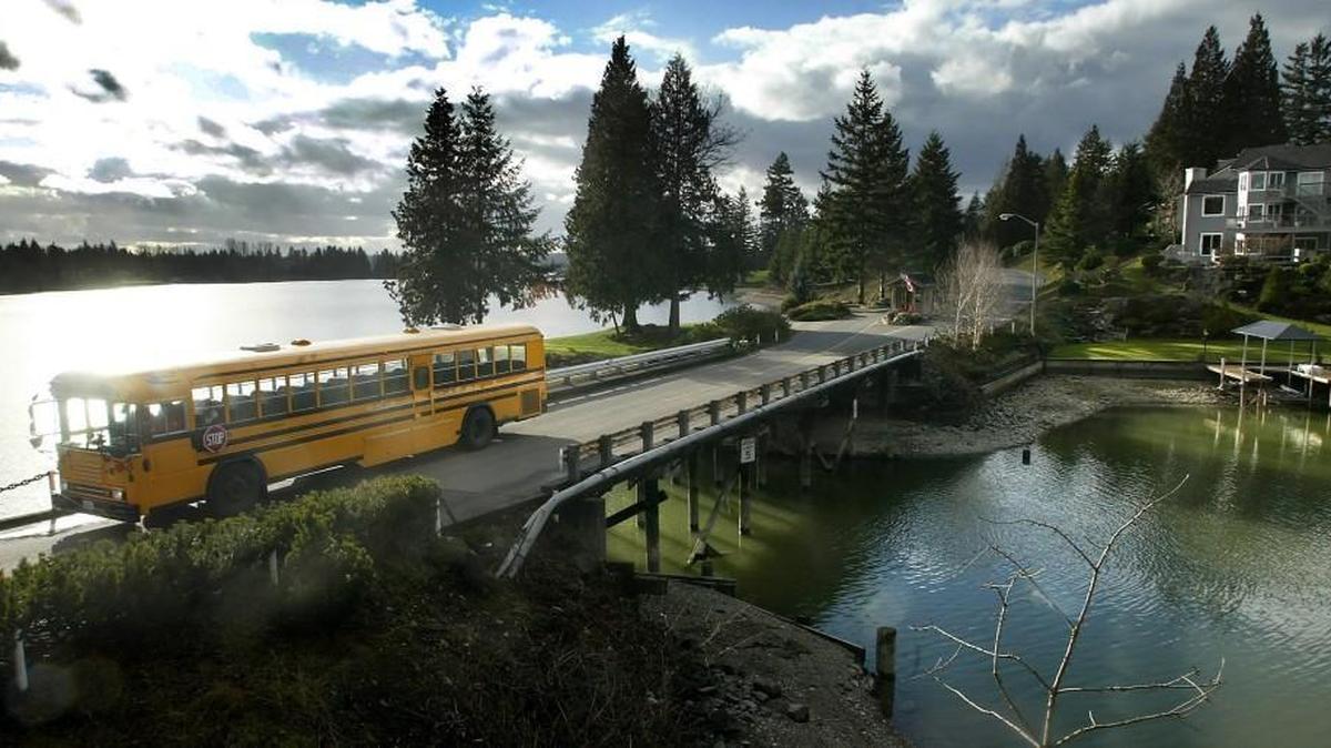 A Dieringer school district bus crosses a narrow bridge leading to Tapps Island.