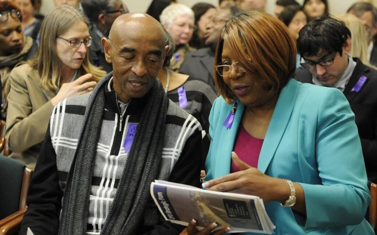 Pastor Toney Montgomery of the Tacoma Ministerial Alliance talks to Black Alliance of Thurston County co-founder Karen Johnson before the House Public Safety Committee hearing Wednesday about two use of deadly force bills.
