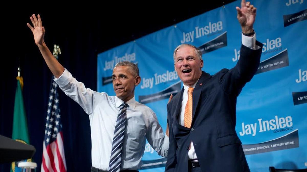 President Barack Obama, left, on stage with Gov. Jay Inslee, right, after speaking at a fundraiser for Inslee at the Washington State Convention Center on Friday in Seattle.