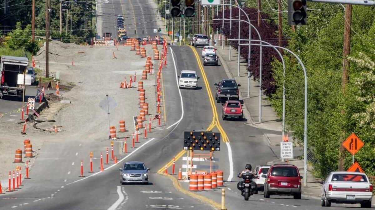 Thirty-ninth Avenue SW near Costco in Puyallup will stay only two lanes wide for a longer period than expected due to a dispute with the contractor.