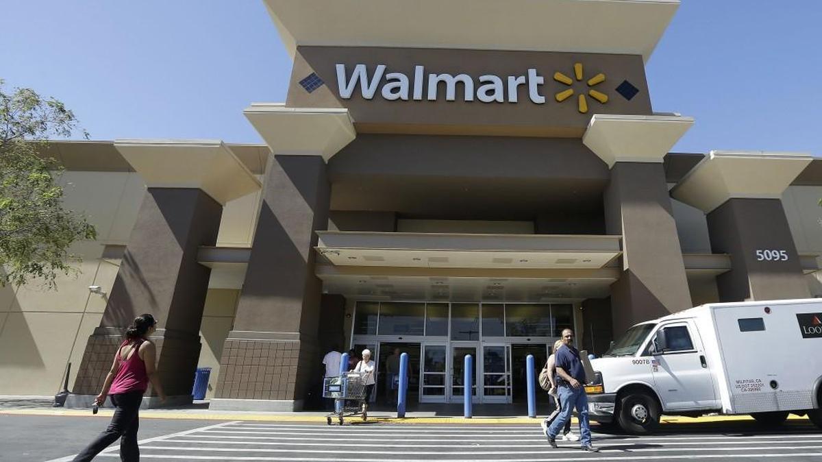 Customers walk outside of a Walmart store in San Jose, Calif., in September 2013.