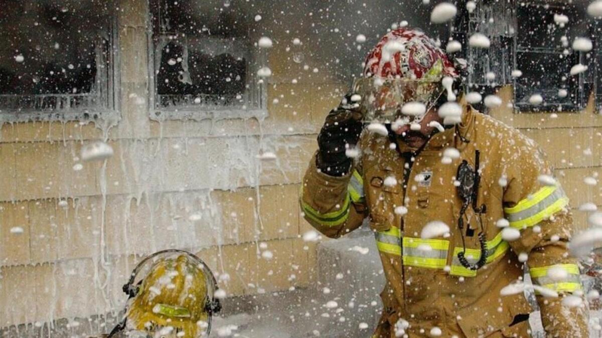 Central Pierce firefighters use retardant foam to battle a house fire in 2006. The state Legislature is considering a bill to limit the sale of some foams which contain chemicals that have been linked to health risks.