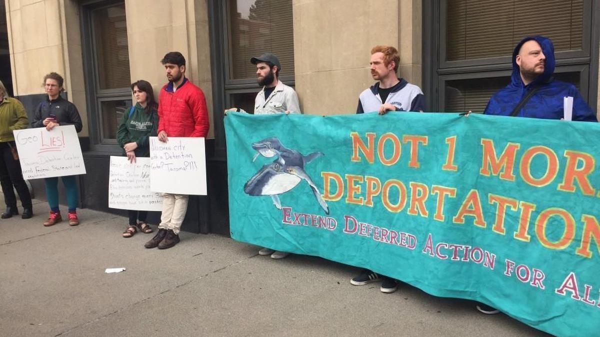 More than a dozen protesters gather Tuesday outside the Tacoma municipal building before a public hearing on the city’s interim regulations for correctional facilities.