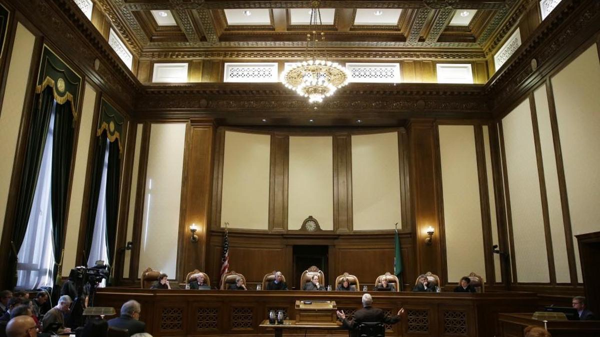 Tom Ahearne, center-right, the lead attorney in a lawsuit against the state of Washington regarding the funding of education, gestures as he speaks Tuesday, Oct. 24, 2017, during a Washington Supreme Court hearing in Olympia, Wash. The hearing was held to determine if Washington state has complied with a court mandate to fully fund the state's basic education system. (AP Photo/Ted S. Warren)
