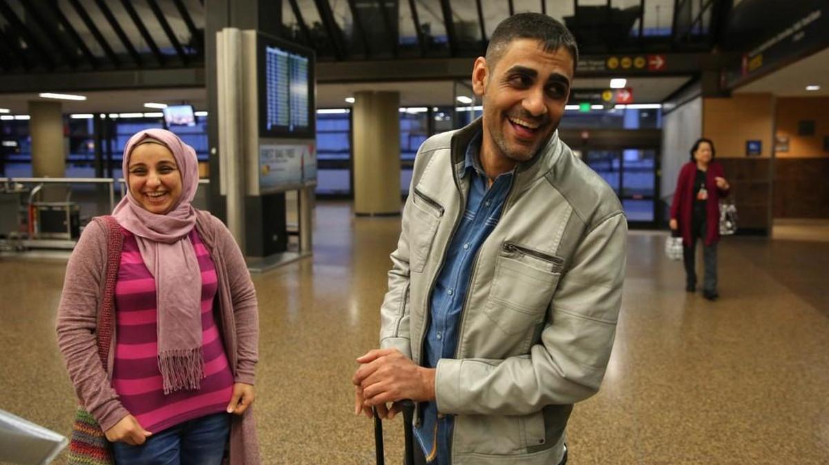 Fouad Alali 34 of Kent, smiles after arriving to Seattle-Tacoma International Airport to meet his sister Zaynab Alali, left, Sunday February 5, 2017, after a federal judge ordered a halt to President Donald Trump’s travel ban. Fouad, a green-card holder and baker at Essential Baking Company, was visiting their sick mother at home in Iraq.