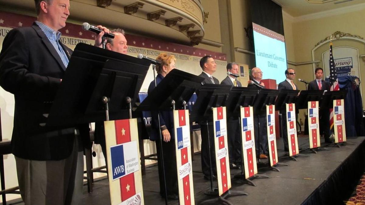 Eight of the 11 candidates for lieutenant governor debate in June in Spokane. From left, Marty McClendon, Paul Addis, Sen. Karen Fraser, D-Olympia; Sen. Steve Hobbs, D-Lake Stevens; Bill Penor, Javier Figueroa, Sen. Cyrus Habib, D-Bellevue; and Phillip Yin, all stand at their podiums. The top two vote-getters in the Aug. 2 primary will advance to the Nov. 8 general election.