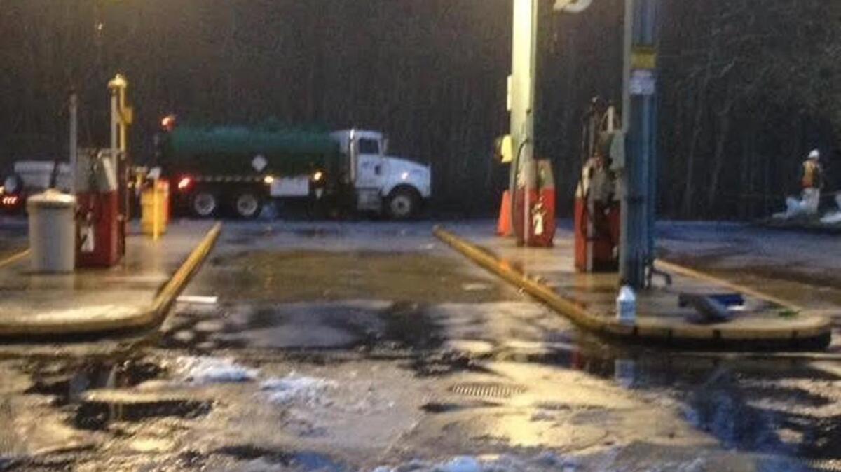 Olympia School District bus barn’s pump island, with contractor’s vacuum truck in background, where a fuel spill was reported Monday afternoon. Crews are cleaning up gasoline that went into a stormwater retention pond behind the truck.