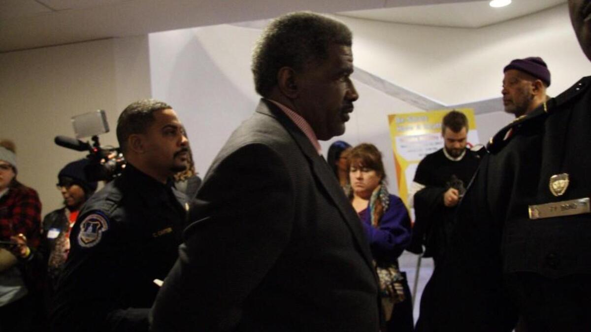 The Rev. Gregory Christopher of Shiloh Baptist Church in Tacoma is led away in handcuffs from a U.S. Senate office building in Washington, D.C., Tuesday afternoon after a protest against the proposed repeal of the Affordable Care Act.