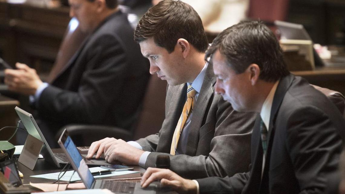Rep. Drew Stokesbary (R-Auburn), left), and Rep. Matt Manweller (R-Ellensburg) check their computers during the final day of the regular legislative session in Olympia on Thursday. Leadership in Washington’s House and Senate all denied requests to release their emails and daily calendars. Legislators have largely exempted themselves from the state public records law, which says “reports or correspondence made or received” by individual members of the Legislature are not public records.