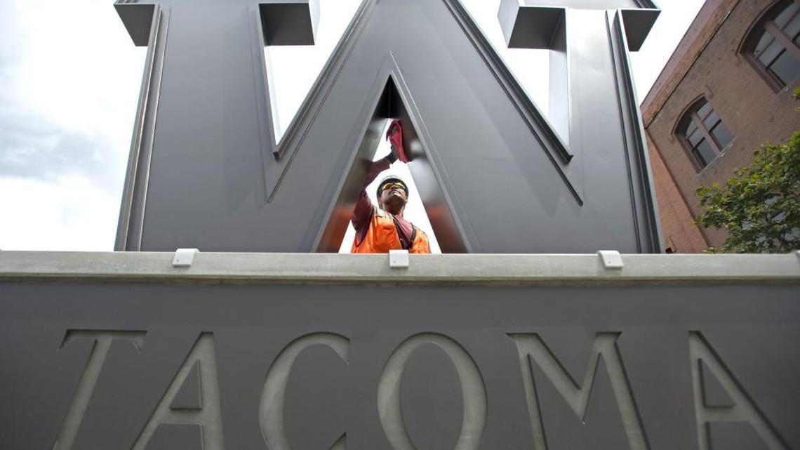 Calvin Fatagi with Marine Vacuum Service cleans the “W” logo for the University of Washington Tacoma on the corner of South 19th Street and Jefferson Avenue in Tacoma on July 21, 2015.