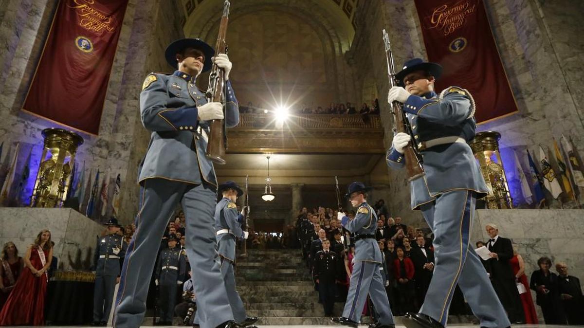 Members of a Washington State Patrol honor guard march in the Capitol rotunda during the Governor’s Inaugural Ball, Jan. 11 in Olympia. More patrol troopers are staying on the job since wages were increased.