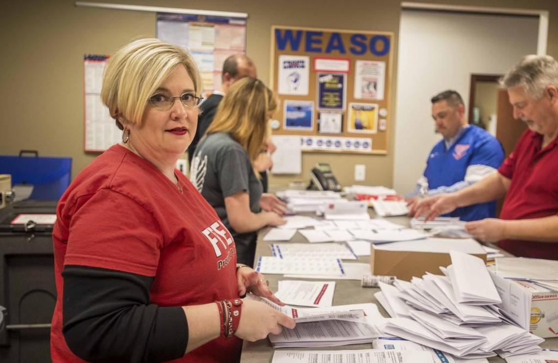 Pam Kruse, president of the Franklin Pierce Education Association, works on a mailing with members of her bargaining team, April 16, 2018.