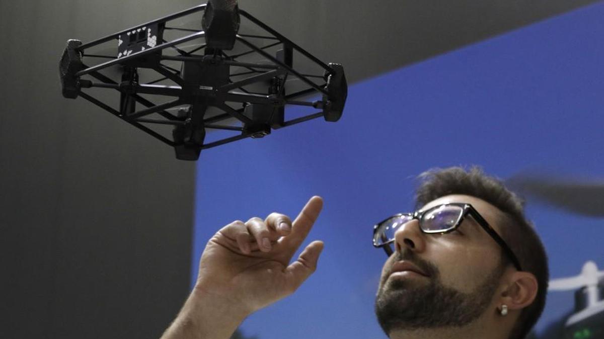 Alex Shapilsky flies the AEE Rova drone near his head at the AEE booth during CES International Jan. 5 in Las Vegas. Washington state lawmakers are looking at new ways to regulate the use of drones, also known as unmanned aircraft.