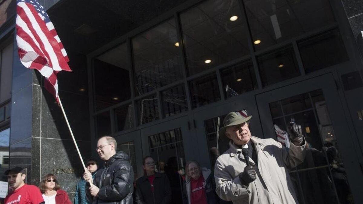 Rev. George Taylor, visitation pastor at All Saints Lutheran Church, speaks in favor of the Affordable Care Act Feb. 13 during a protest against the repeal of the law. The audience was a hundred people standing in front of the Peyton building, where Rep. Cathy McMorris Rodgers has her Spokane office.