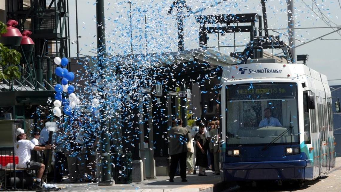 Confetti flies through the air as a Tacoma Link train pulls out of the Tacoma Dome Station on the first public day of operation, August 22, 2003. The original six-stop light-rail line is closer to being expanded to 12 stations as the city of Tacoma received a $15 million federal grant to help cover its $40 million share of project costs.