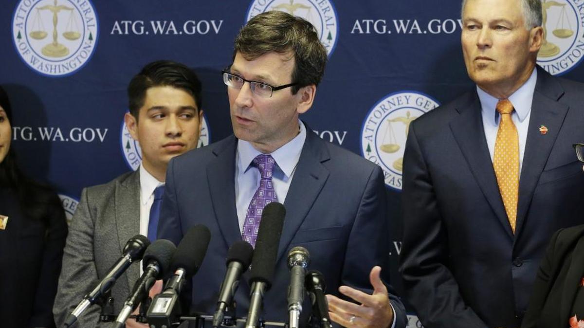 Washington Attorney General Bob Ferguson, center, talks to reporters, Wednesday, Sept. 6, 2017, in Seattle, as Gov. Jay Inslee, right, looks on. More than a dozen states and the District of Columbia filed a lawsuit to block President Donald Trump's plan to end the Deferred Action for Childhood Arrivals, or DACA program. Some say Ferguson is capitalizing on his legal actions against the president to raise money for a possible gubernatorial run.