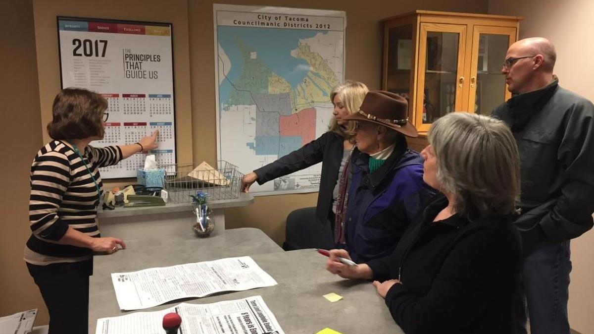 Members of Save Tacoma Water file a petition for a city charter amendment at the Tacoma city clerk’s office.