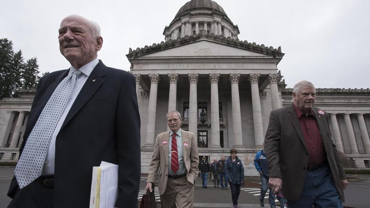Dick Warbrouck, left, from Edmonds, president of the Retired Firefighters of Washington; Dave Peery, center, Law Enforcement Officers and Firefighters (LEOFF) Plan 1 secretary from Seattle, and retired firefighter Bob Fuhrmann of Lacey arrive with fellow members of the LEOFF 1 Coalition for a hearing on the Capitol Campus in Olympia last week. The group opposes a plan to merge the LEOFF 1 pension with the teachers retirement system.