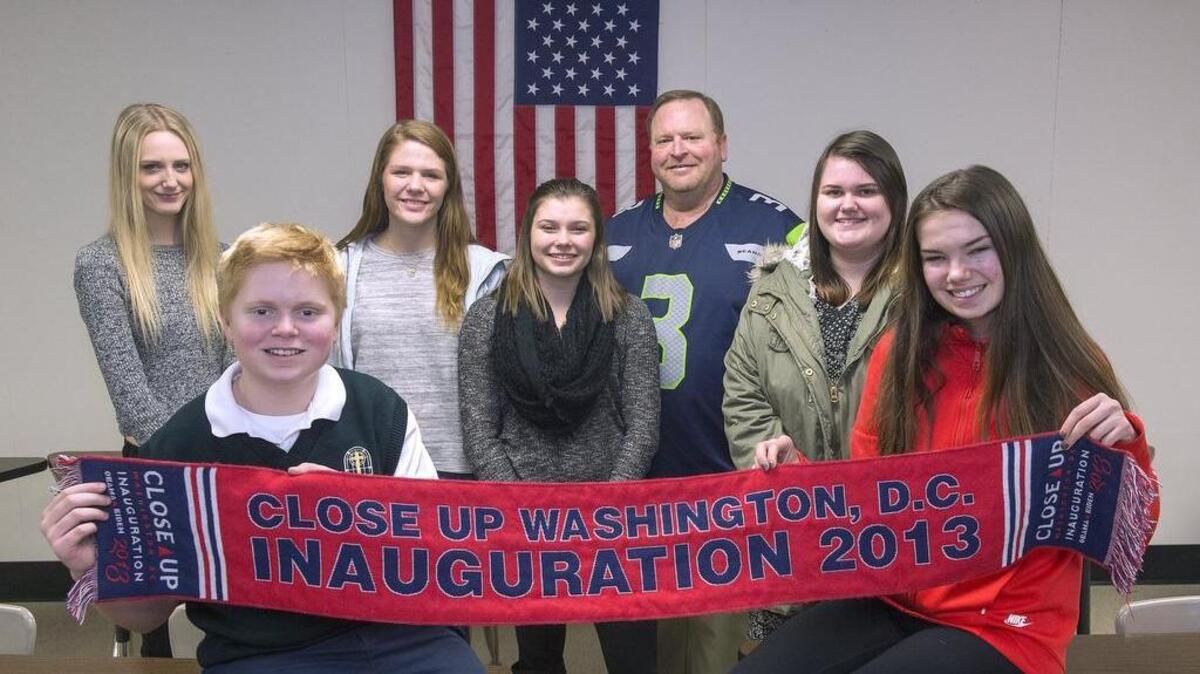 Tim Messersmith, a U.S. history and civics teacher at Peninsula High, stands with some of the students he’ll be escorting to Washington, D.C., to attend the inauguration of president-elect Donald Trump. “The purpose of the visit is to give the kids a chance to witness history, the peaceful transfer of power. The inauguration will be a living classroom,” Messersmith said. It will be the teacher’s second experience attending an inauguration with students, and he’s intrigued to see how it compares with Obama’s in 2013, where he acquired this souvenir scarf. From left: Kourtney Roberts, 17, of Peninsula High; Taggart Messersmith, 12, St. Nicholas Catholic School; Jamie Freeburg, 16, Bellarmine Prep; Lissa Racette, 17, Peninsula; Tim Messersmith; Holly Lake, 17, Peninsula and Payton Schneider, 16, Bellarmine Prep. Also going are Bailey Turner, 17, Peninsula and Karly Ward, 18, Bellarmine Prep.