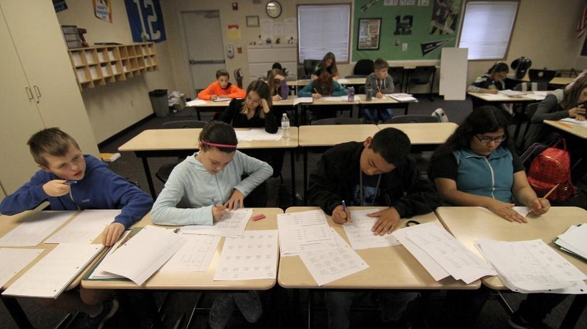 Sixth-grade students at Ballou Junior High in Puyallup work on classroom assignments during math studies in 2015. This year, some Washington state lawmakers want to revive parts of Initiative 1351, a class-size reduction measure voters approved in 2014.
