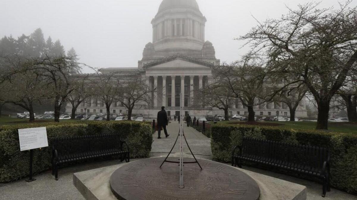 The Legislative Building and the sundial is shown on a foggy morning at the Capitol in Olympia.