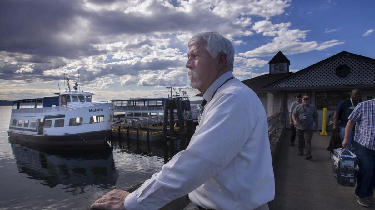 Bill Van Hook, a former assistant attorney general who came out of retirement to take over as the Special Commitment Center CEO, watches employees get off the ferry at the Steilacoom dock on Monday.