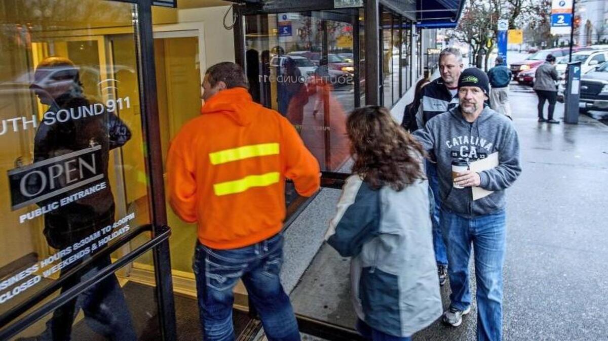 Individuals seeking concealed pistol licenses enter the South Sound 911 offices Dec. 21, 2015. Concealed pistol licenses issued by the agency from Jan. 4 to March 31 are missing issuing agency information. South Sound 911 will replace the licenses for free.