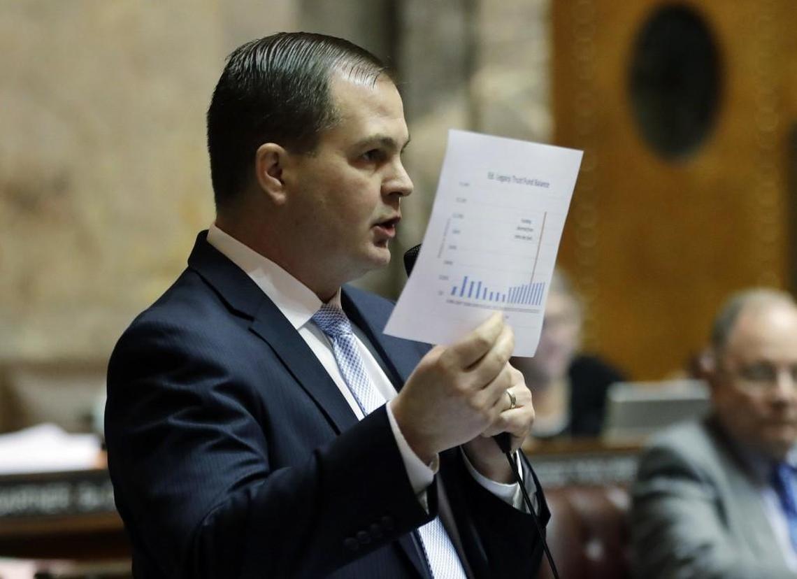 Sen. John Braun, R-Centralia, holds up a chart as he speaks on the Senate floor during debate over the supplemental budget, Thursday, March 8, 2018, at the Capitol in Olympia, Wash., on the final day of the regular session of the Legislature. (AP Photo/Ted S. Warren)