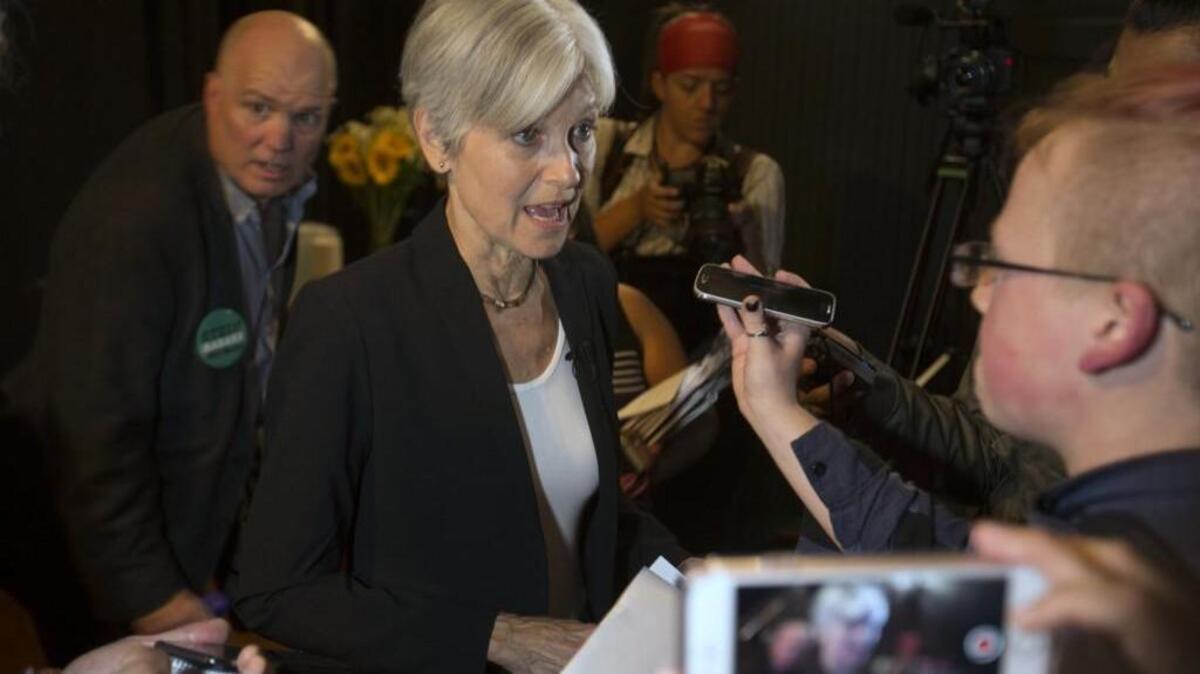 In this Oct. 6, 2016, photo, Green party presidential candidate Jill Stein, center, takes questions from reporters during a campaign stop at Humanist Hall in Oakland, Calif. (AP Photo/D. Ross Cameron)