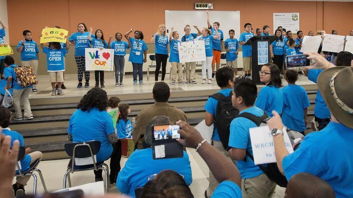 Onlookers record and savor cheers by students during a rally supporting school choice at Destiny Charter Middle School in Tacoma on Thursday, Sept. 10, 2015.