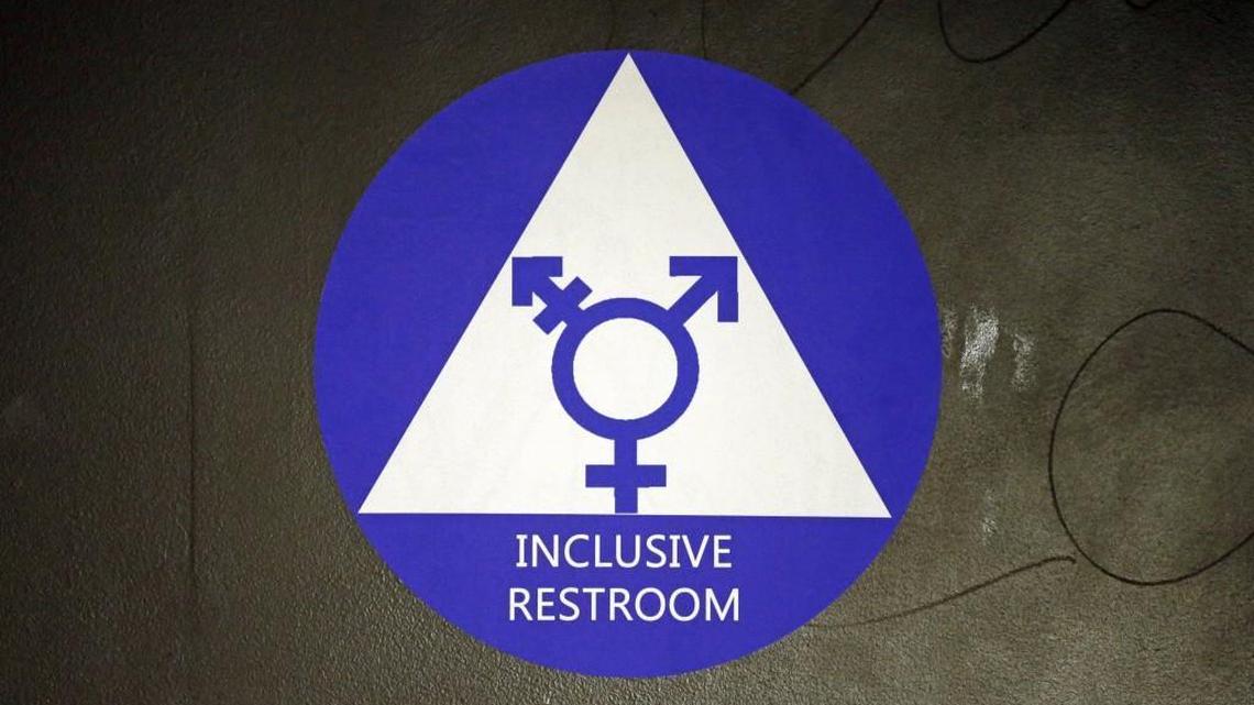 FILE - In this May 17, 2016, file photo, a new sticker designates a gender neutral bathroom at Nathan Hale high school in Seattle. (AP Photo/Elaine Thompson, File)