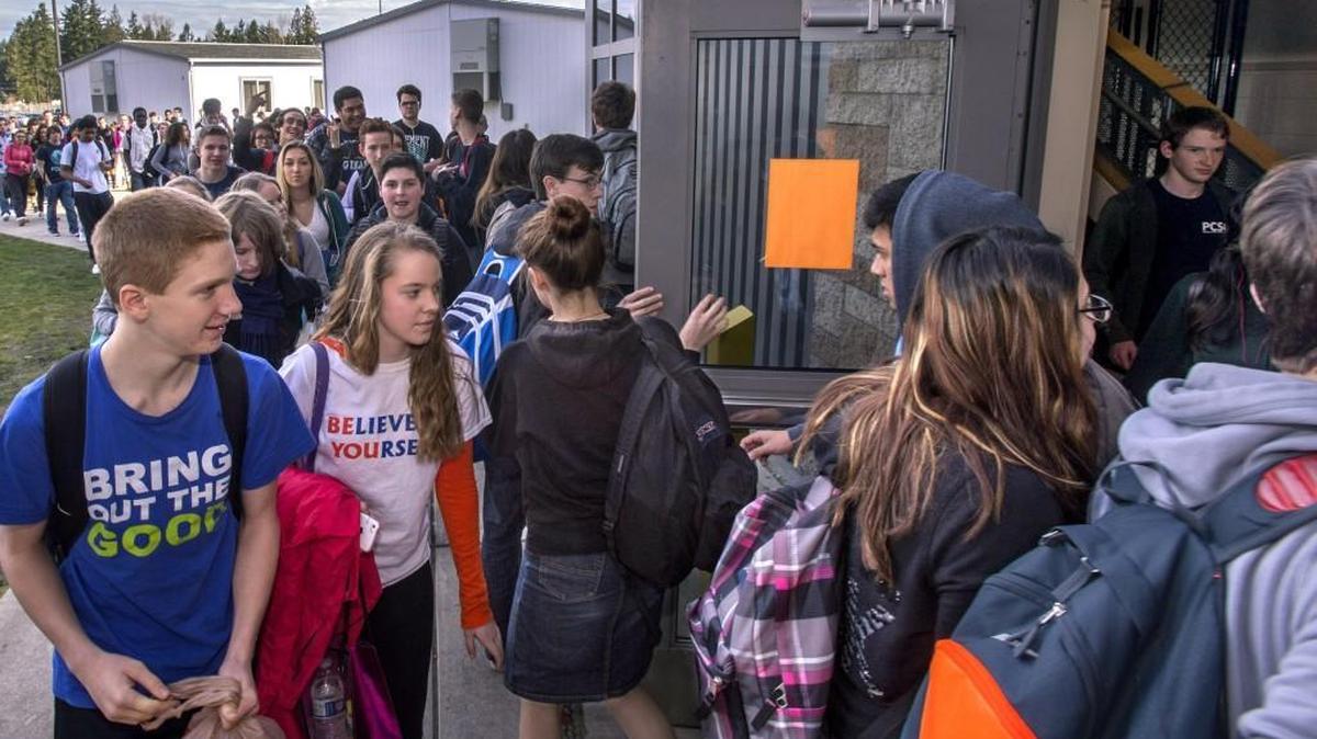 Graham-Kapowsin High School students clog a doorway Friday between 18 portable classrooms and the overcrowded school in Graham. The high school was built to accommodate 1,400 students. But 1,950 students are enrolled this year.