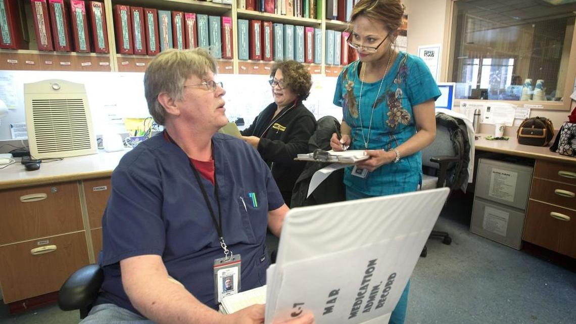 Western State Hospital employees Paul Malinosky, Niebes Cabigting Ragasa and Maria Engelhardt Parales, from left, were expecting help from new hires in 2015. There have been new hires since then, but further pay hikes are proposed to attract and keep nurses and others working at the hospital. Other critical state employees would also get raises.