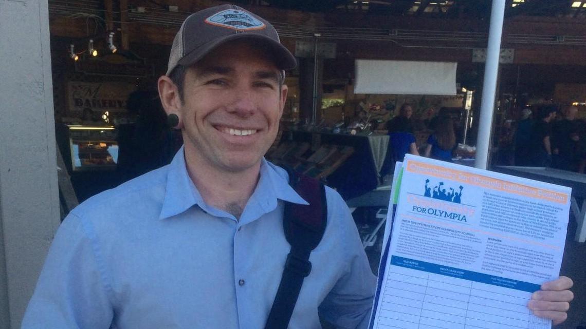 Ray Guerra collects signatures for the Opportunity for Olympia campaign on April 7 at the Olympia Farmers Market.