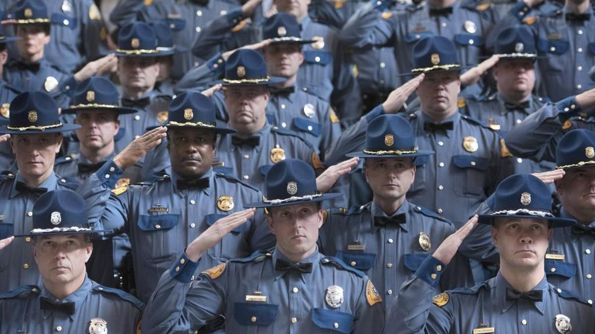Washington State Patrol troopers and senior officers stand at attention during the Washington State Patrol new trooper graduation ceremonies in the Capitol Rotunda in Olympia on Nov. 19.