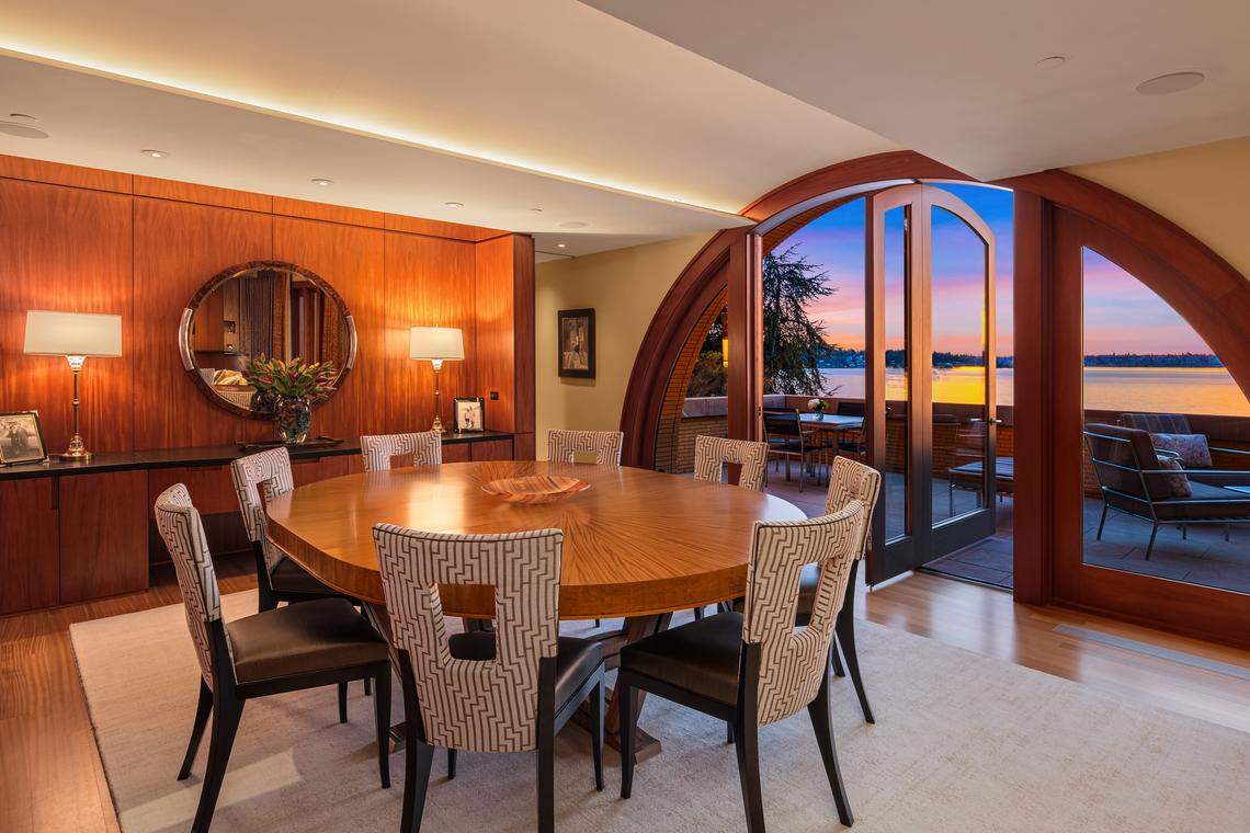 The dining room has half-circle doors that open onto a balcony.
