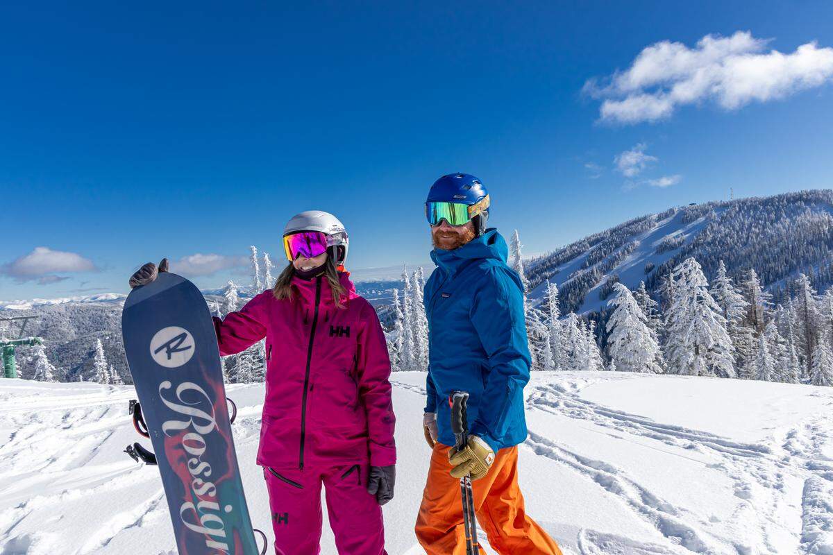 A snowboarder and skier are shown at 49°North Mountain Resort in Chewelah, Washington.